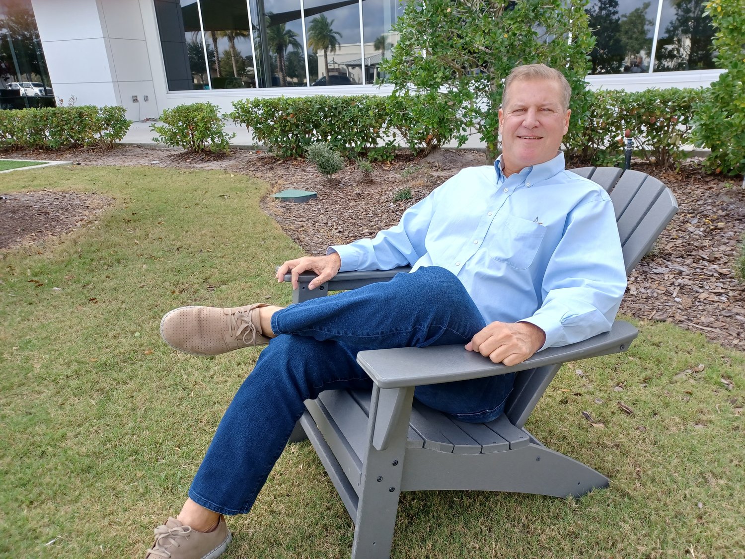 Steven Hertzberg relaxes outside the link where he maintains a dedicated desk for his business.